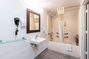 a bathroom with a sink and a shower at Quality Inn & Suites in Dickson +20 photos
