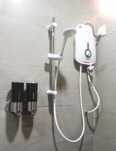 a shower in a bathroom with a hair dryer at SUNBAY INN in Semporna