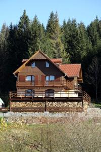 a large wooden house in the middle of a forest at Penzión Ľadová in Stratená