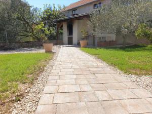 a brick walkway in front of a house at Fyaka Loft Apartments in Vodice