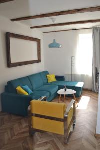 ein Wohnzimmer mit einem blauen Sofa und einem Tisch in der Unterkunft Historical apartments V18 in Košice