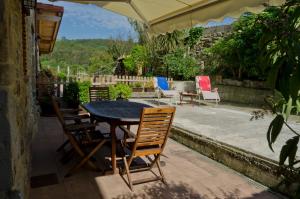 a table and chairs sitting on a patio at Apartamentos Playa Galizano in Galizano
