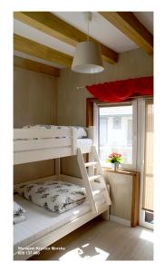 a white bunk bed in a room with a window at Los Reyes II - klimatyzowane pokoje in Krynica Morska