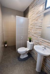 a bathroom with a toilet and a sink at เซฟเฮ้าส์รีสอร์ท บางใบไม้ in Suratthani