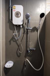 a shower in a bathroom with a blow dryer at เซฟเฮ้าส์รีสอร์ท บางใบไม้ in Suratthani