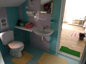 a bathroom with a toilet and a sink at Family House Near Motorway 6 Guests 3 Bedrooms in Veles