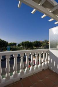 a white railing on a balcony with a view at Hostal Europa in Estepona