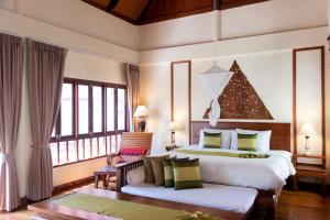 a bedroom with two beds and a christmas tree at Royal Lanta Resort & Spa in Ko Lanta