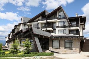 a large building with balconies on the side of it at Aspen golf studio apartment D208 in Razlog