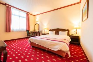 Postel nebo postele na pokoji v ubytování East Commercial Affairs Hotel