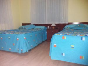 Postel nebo postele na pokoji v ubytování Hostal Residencia Delfin