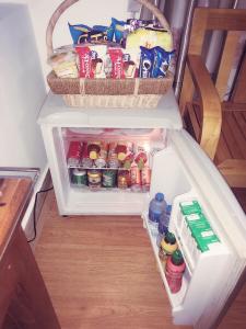 an open refrigerator filled with food and drinks at OYO 1143 Thu Giang Hotel in Hanoi