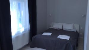 a bedroom with a bed with two towels on it at Sopot, BIG APARTMENT FOR 6!!! Air condition, jacuzzi in Sopot