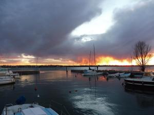 a group of boats docked in a marina at sunset at Affittacamere Porticciolo in Castelnuovo del Garda