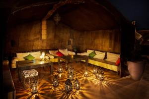 a room with a couch and tables and lights at Riad Sofia in Marrakesh
