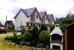 a house with a bird house in front of it at Baltic Neptun in Jastrzębia Góra