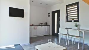 a living room with a table and chairs and a kitchen at Baltic Neptun in Jastrzębia Góra