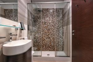 a bathroom with a sink and a shower at Hotel City in Desenzano del Garda