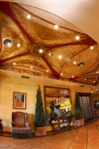 a lobby with a room with a ceiling with lights at Apartamentos Club Condal in Comillas