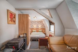 a bedroom with a bed and a desk at Hotel Fevery in Bruges