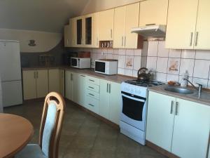 a kitchen with white cabinets and white appliances at Agroturystyka Anita in Rutka Tartak