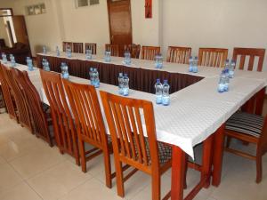 a long long table with chairs and glasses on it at Mirema Hotel in Nairobi