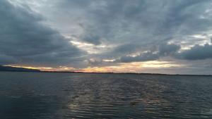 a cloudy sky over a large body of water at b&b ilfenicottero in Orbetello +8 photos