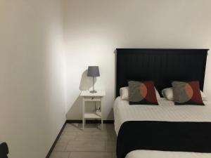 a bedroom with a bed and a table with a lamp at Casa Elena in Camporgiano