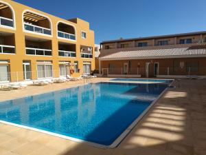 a large swimming pool in front of a building at Vida Cotillo - No Stress Holidays in El Cotillo
