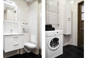 biała łazienka z toaletą i pralką w obiekcie Prestige Apartments 7 we Wrocławiu