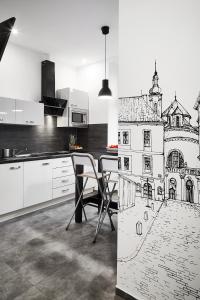 a kitchen with a drawing of a building at Prestige Apartments 7 in Wrocław