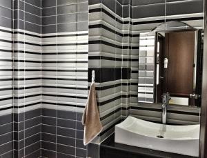 a black and white bathroom with a sink and a mirror at Jintana Resort in Buriram +124 photos