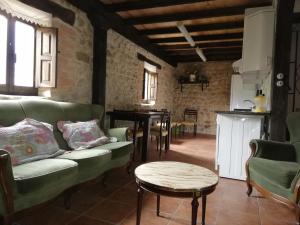 a living room with a couch and a table at Algarabiastaying 2 granja San Julián in Medina de Pomar