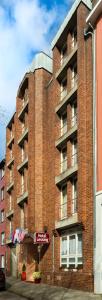 a red brick building with an apartment building at Hotel Lessing in Düsseldorf