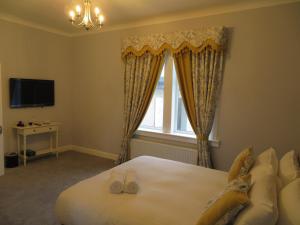 Un dormitorio con una cama grande y una ventana en Craigievar Guest House en Edimburgo