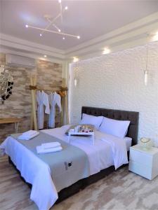 a bedroom with a large bed with a tray on it at Petite Palace Aristotelous 8 in Thessaloniki