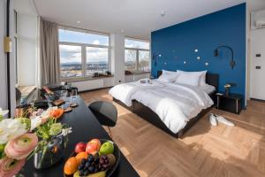 a bedroom with a blue accent wall and a bed at Schlossberg Hotel Homburg in Homburg