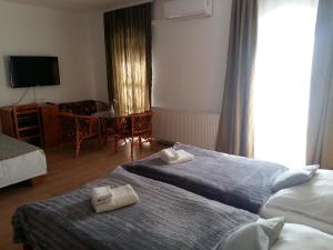 Postel nebo postele na pokoji v ubytování Retro Panzió