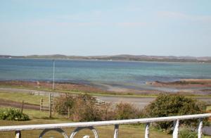 a view of a body of water from a balcony at The Glebe, Am Fasgadh in Bowmore