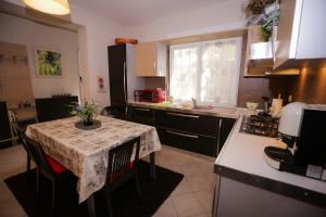 a kitchen with a table with a table cloth on it at Pine-Tree Apt w/ Private Garden 50 m from the Sea in Golem