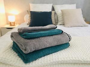 a pile of towels sitting on top of a bed at Studio Cathédrale Vieux-Port - Mucem - Vieille Charité in Marseille