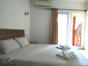 a bedroom with a bed with two towels on it at Durak Hotel ölüdeniz in Oludeniz
