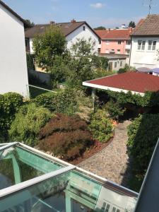 a view of a garden from the balcony of a house at First Floor Olching in Olching