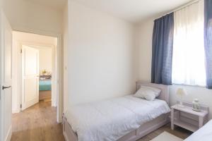 Postel nebo postele na pokoji v ubytování Adorma Hum