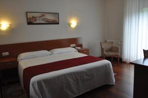 Ein Bett oder Betten in einem Zimmer der Unterkunft Pension Alameda