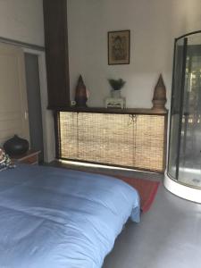 a bedroom with a blue bed and a window at Baba pim villa in Chiang Mai