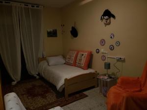 a small bedroom with a bed and a window at Can Josep in Aldover +18 photos