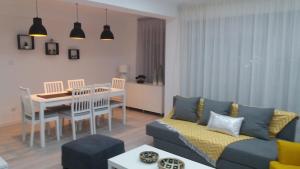 a living room with a couch and a dining room at Sunset House Azores in Ponta Delgada