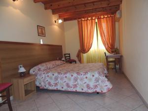 a hotel room with two beds and a window at La marina in Cagliari