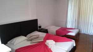 
a bed room with two beds and two nightstands at Mediterranean Blue in Kavos

